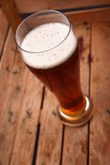 Tall glass of beer in a crate