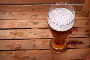 Tall glass of beer in a crate