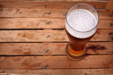 Tall glass of beer in a crate