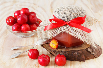 Jam, confiture of Malpighia glabra (red acerola) in jar and fres