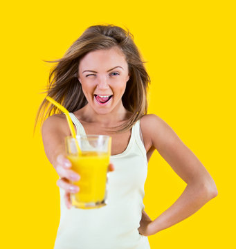 Teenager Girl Drinking Orange Juice On Yellow Background