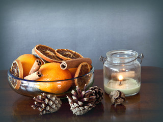 Simple Christmas: bowl with spices and fruits and a candle