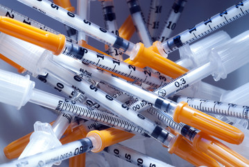 a pile of syringes for insulin