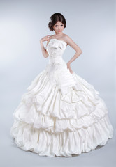 Fototapeta na wymiar Attractive bride model girl wearing in wedding dress with volumi