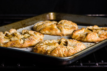 Apple tarts on a baking tray