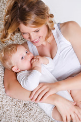 Young mother playing with her little son.