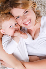 Young mother playing with her little son.