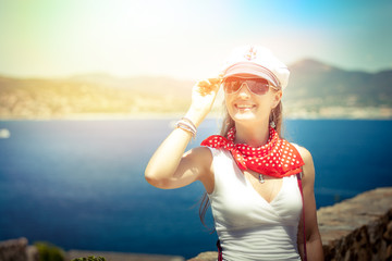 Beautiful girl enjoys the sun in the Bay of Saint-Tropez