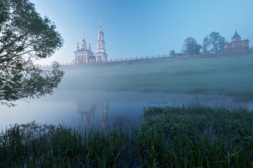 Landscape with two churches and foggy river