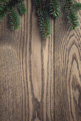 fir branch on stained oak table from above