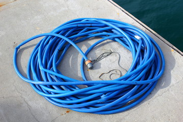 blue Hose pipe coiled on pontoon