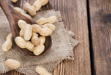 Some Peanuts on a wooden spoon