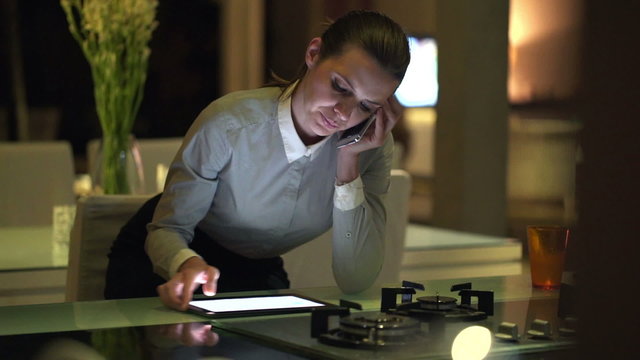 oung businesswoman with cellphone and tablet computer