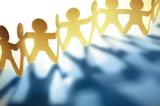 Teamwork paper chain people together holding hands