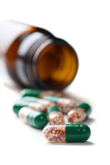 pills in pill bottle on white background