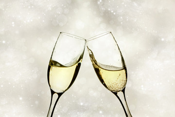 Champagne glasses against holiday lights