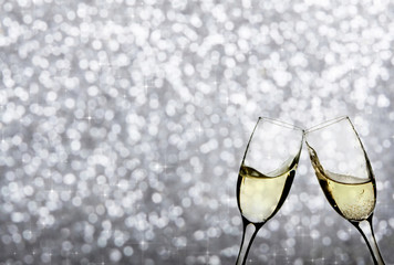 Champagne glasses against holiday lights