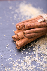 Star anise with cinnamon sticks over black stones background 