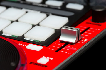 DJ mixer controller. Fader and buttons of red mixing console.