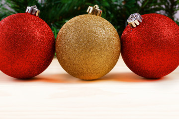 Christmas balls with fir-tree branches on wooden background