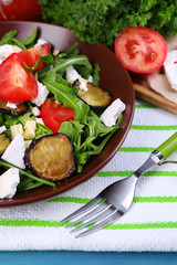 Eggplant salad with tomatoes, arugula and feta cheese,