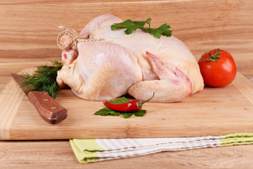 Raw chicken on wooden table