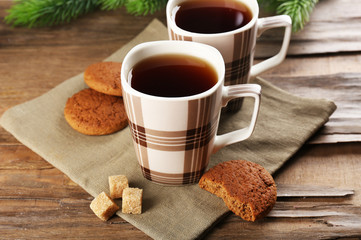 Cups of tea with cookies on table close-up