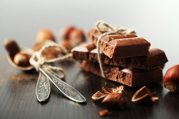 Tasty porous chocolate with nuts on table, close up