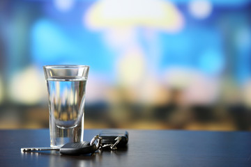 Glass of alcoholic drink and car key,