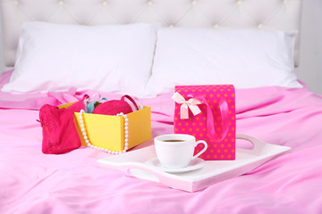 Seductive lingerie in present box and tray with cup of coffee