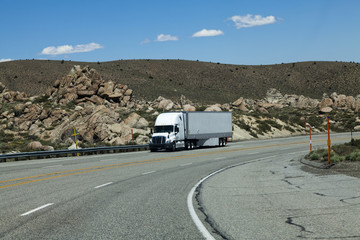 Obraz premium Truck Coming Downhill On Four Lane Highway