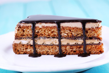 Delicious chocolate cake on plate on table close-up