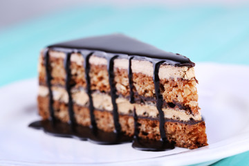 Delicious chocolate cake on plate on table close-up