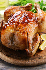 Delicious baked chicken on table close-up