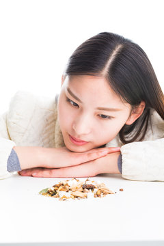 looking at a pile of Chinese herbs.