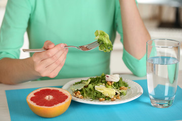 Girl and dietary food at table close-up