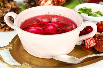 Traditional polish clear red borscht with dumplings and