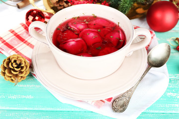 Traditional polish clear red borscht with dumplings and
