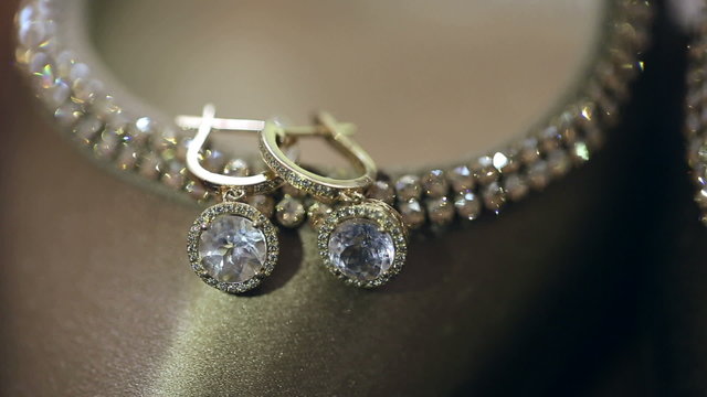 Beautiful gold earrings with diamonds. Close up