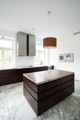 Kitchen with brown furniture