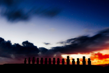 Silhouettes of fifteen moais against starry blue sky in Easter I