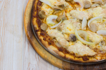 Delicious chicken pizza on wood