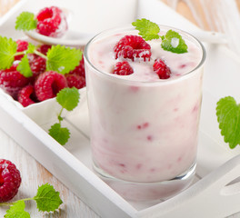 Fresh raspberry yogurt in a glass.