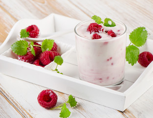 Raspberry yogurt with mint leaves