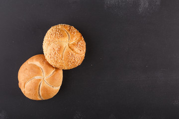 kaiser bread on dark chalkboard