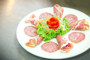 Fototapeta na wymiar Delicious and tasty meat dishes. Parma Ham, salami.