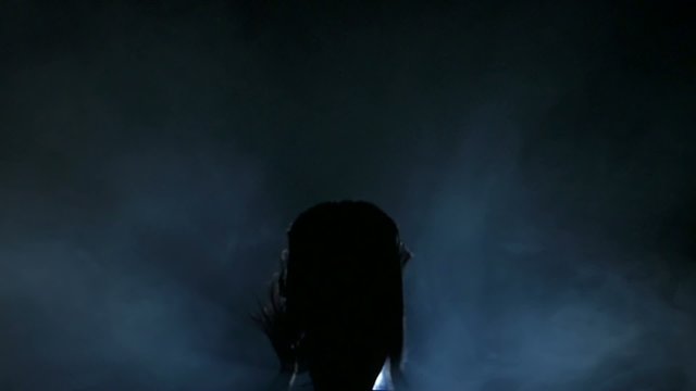 Dancing silhouettes of woman in a nightclub. Slow motion.