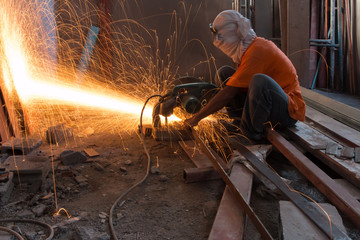 Man cutting and welding at work shop
