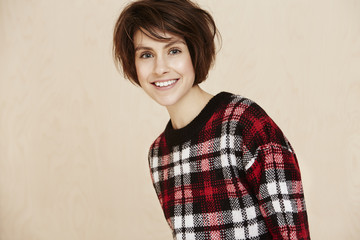 Portrait of mid adult woman in checked top.