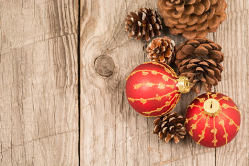 Christmas baubles and pine cones top view